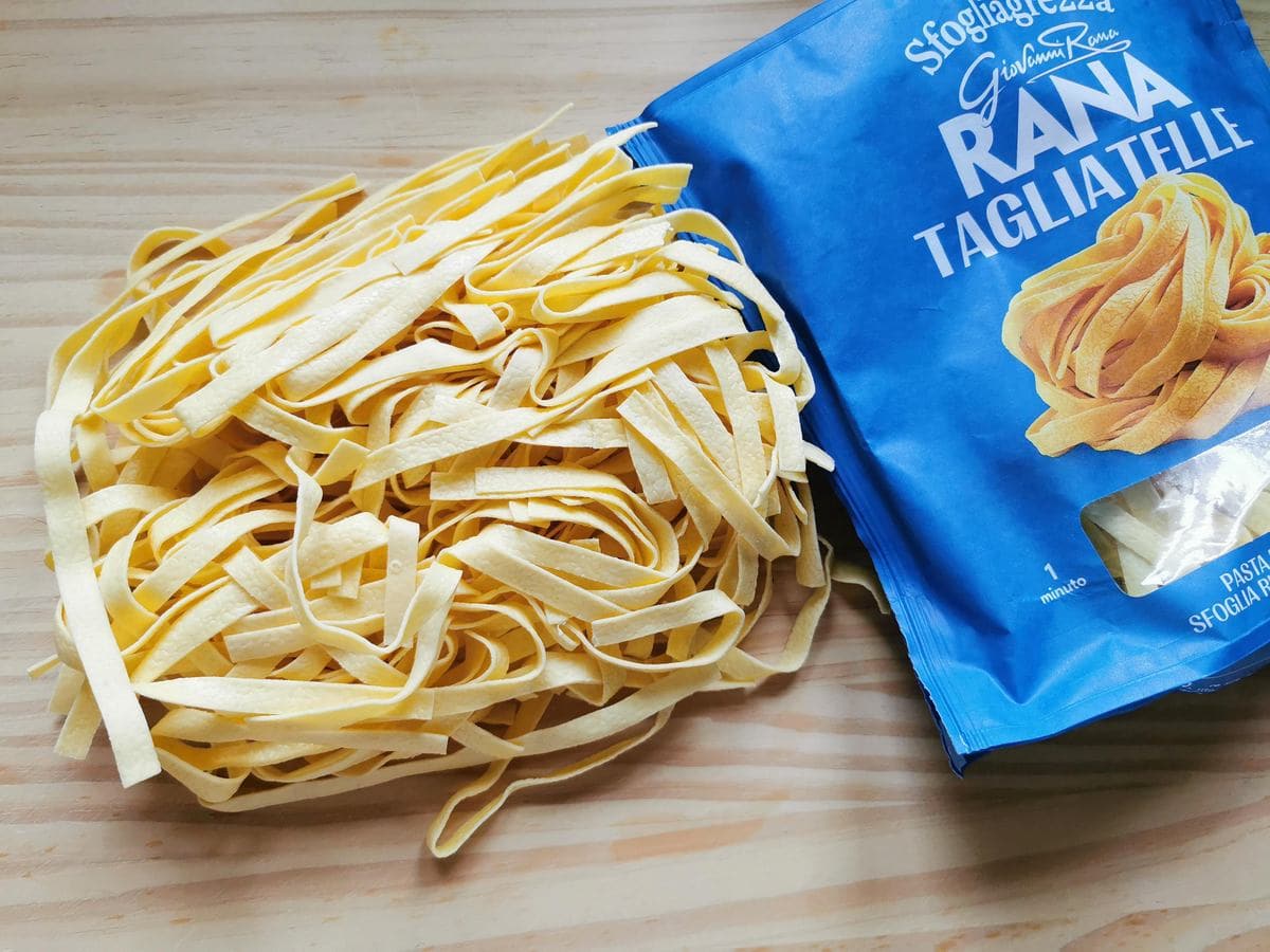 Fresh tagliatelle from Giovanni Rana on wood worktop.