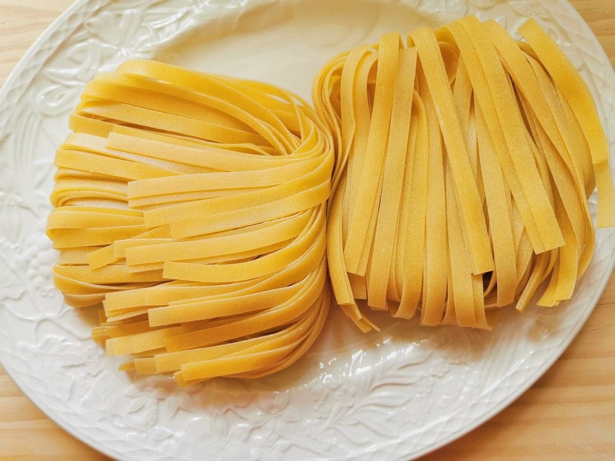 Fresh tagliatelle noodles on a plate.