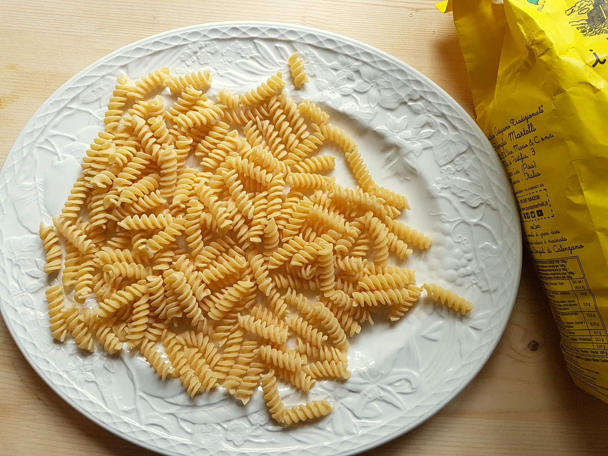 Dried fusilli pasta on a plate.