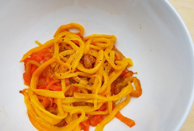 bell pepper julienne in white bowl with olive oil