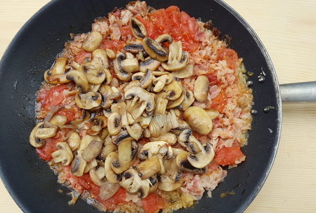 mushrooms and tomato sauce in frying pan for garganelli pasta alla zingara