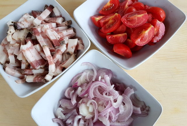 chopped tomatoes, shallots and guanciale in white bowls