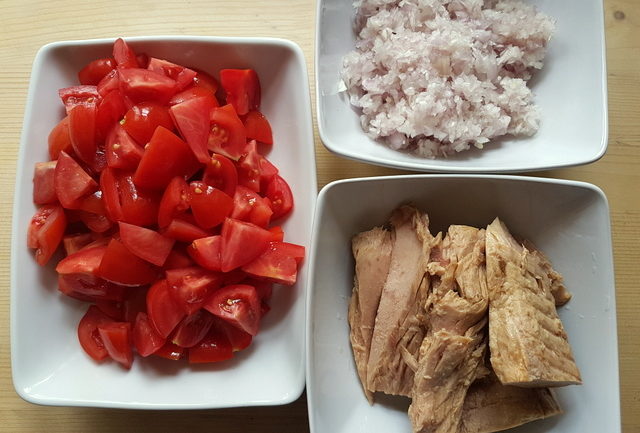 chopped tomatoes, drained canned tuna and finely chopped onion in 3 white bowls