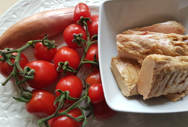 ingredients for pasta with tuna Bolognese on white plate