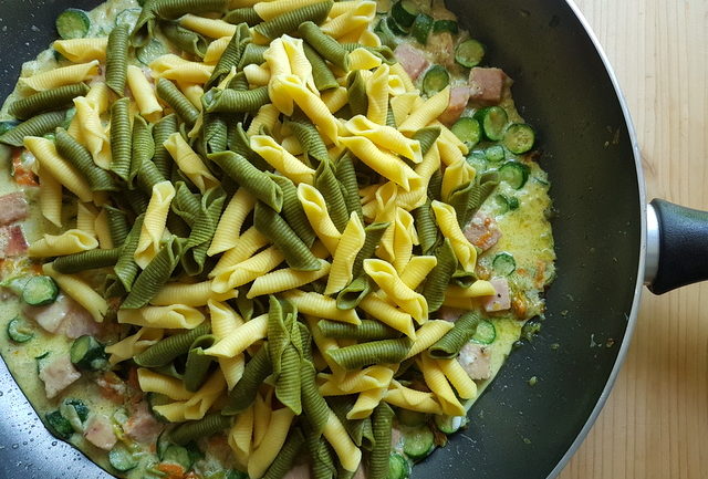 garganelli pasta with zucchini flowers, saffron and ham