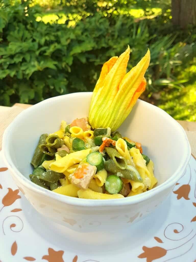 garganelli pasta with saffron, zucchini flowers and ham