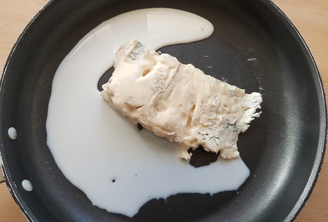 Gorgonzola and milk in frying pan