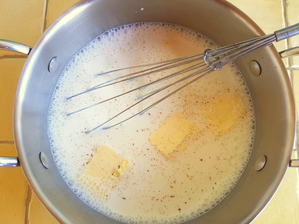 milk and butter pieces in saucepan