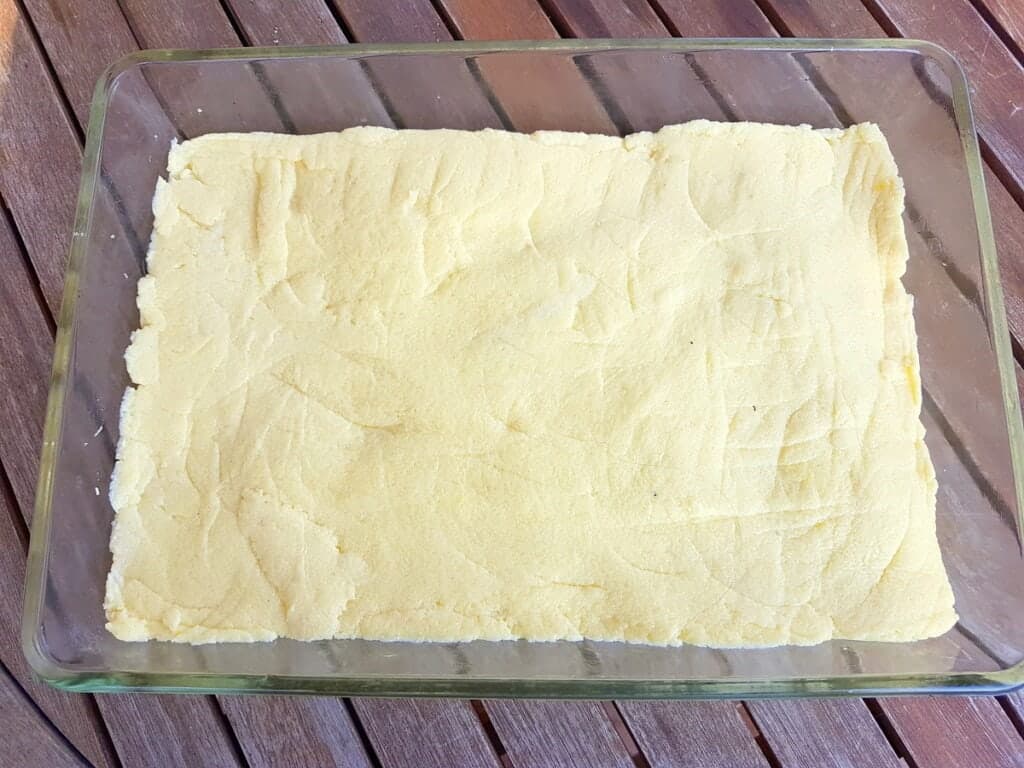 gnocchi dough flattened into a rectangular pyrex dish