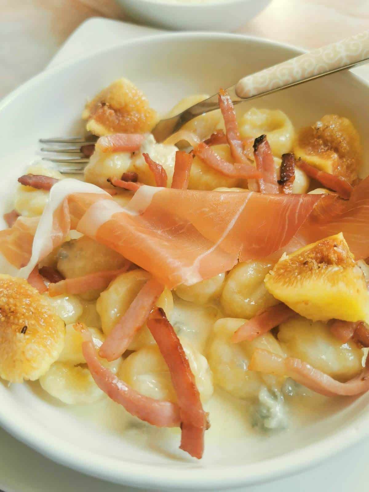 Gorgonzola gnocchi with traditional Italian toppings - Speck and figs.