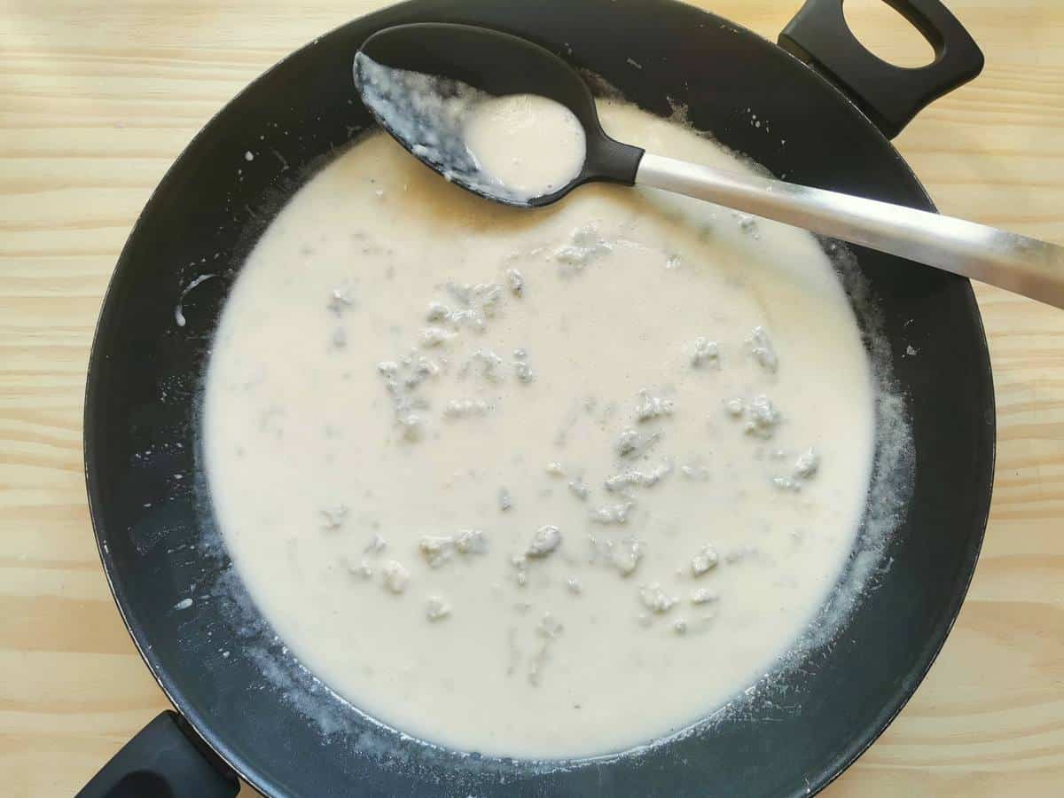 Gorgonzola sauce in a skillet.