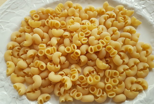 dried gomiti elbow pasta (chifferi) on white plate