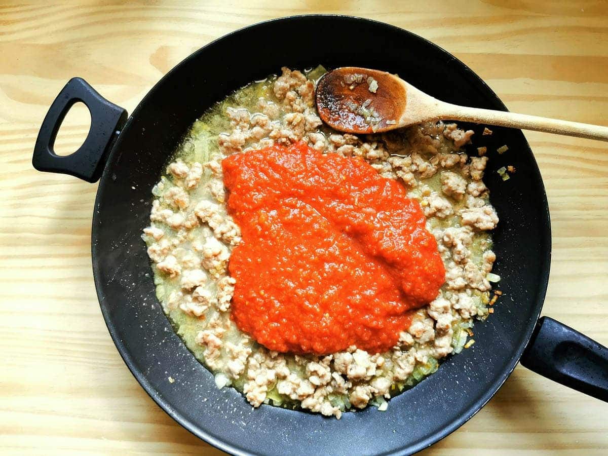 canned tomatoes and stock added to the sausage