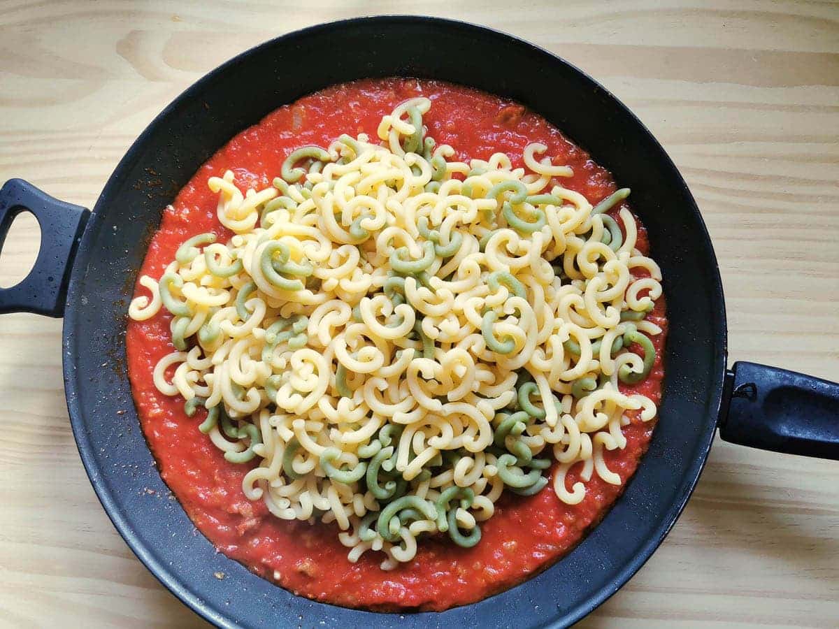 gramigna pasta added to the sausage tomato sauce