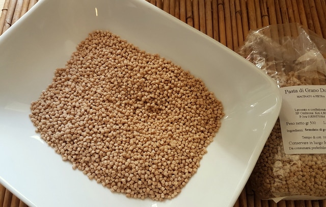 dried grattoni-grattini pasta for soup in a white bowl