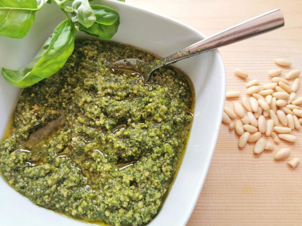 homemade basil pesto in white bowl