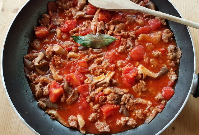 sauce for homemade cavatelli pasta with oyster mushrooms and sausage in frying pan