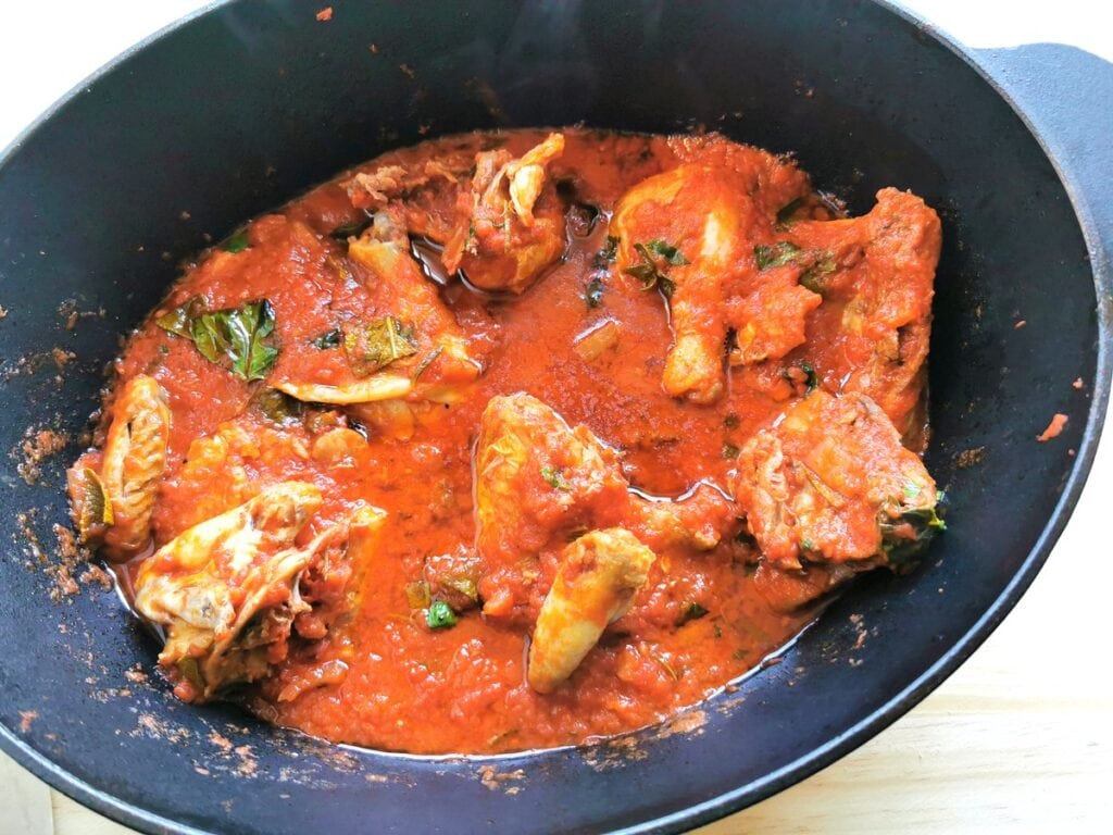 Chicken ragu cooking in a pot.