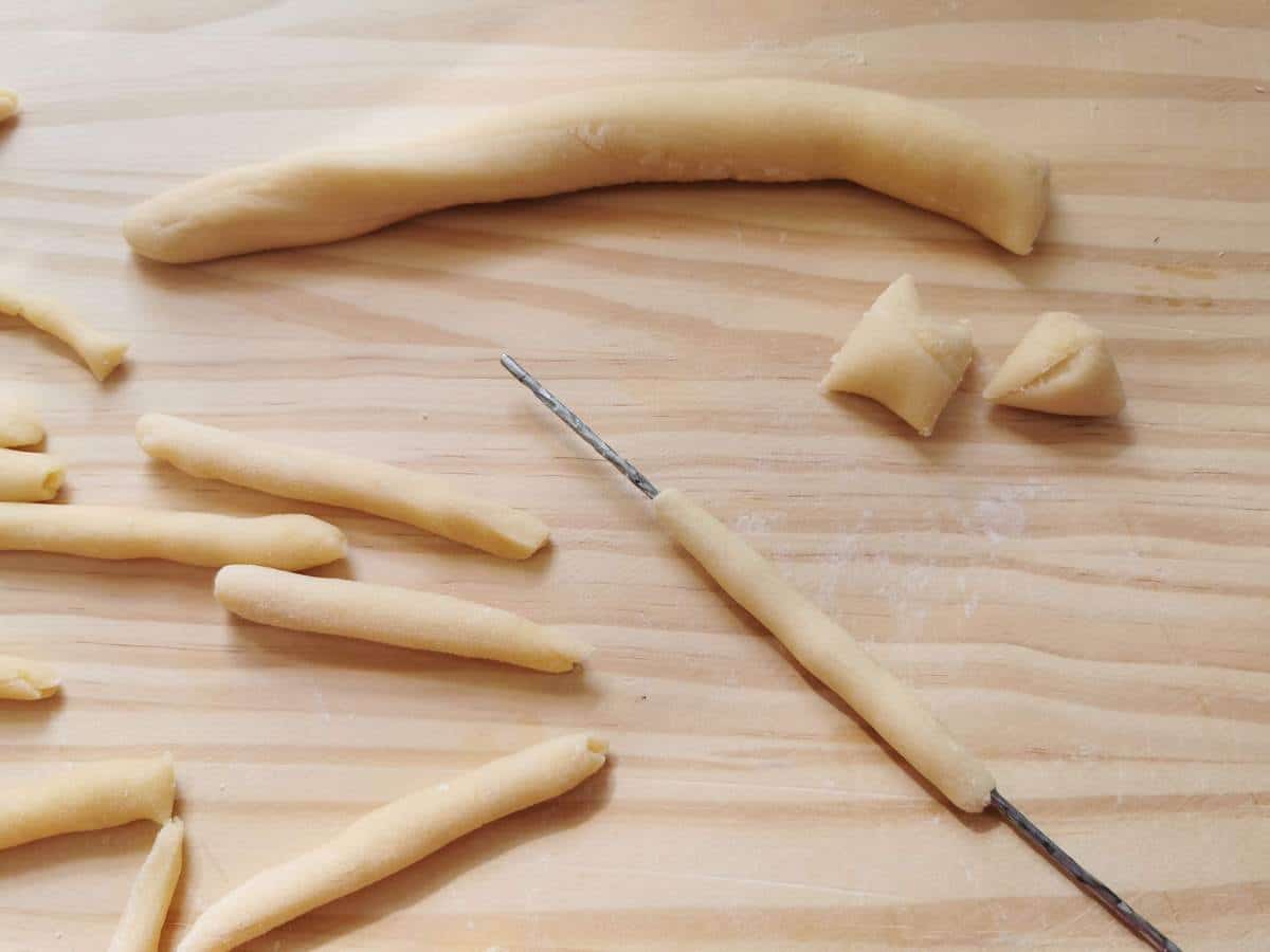 Ready maccheoni al ferretto on wood work surface.