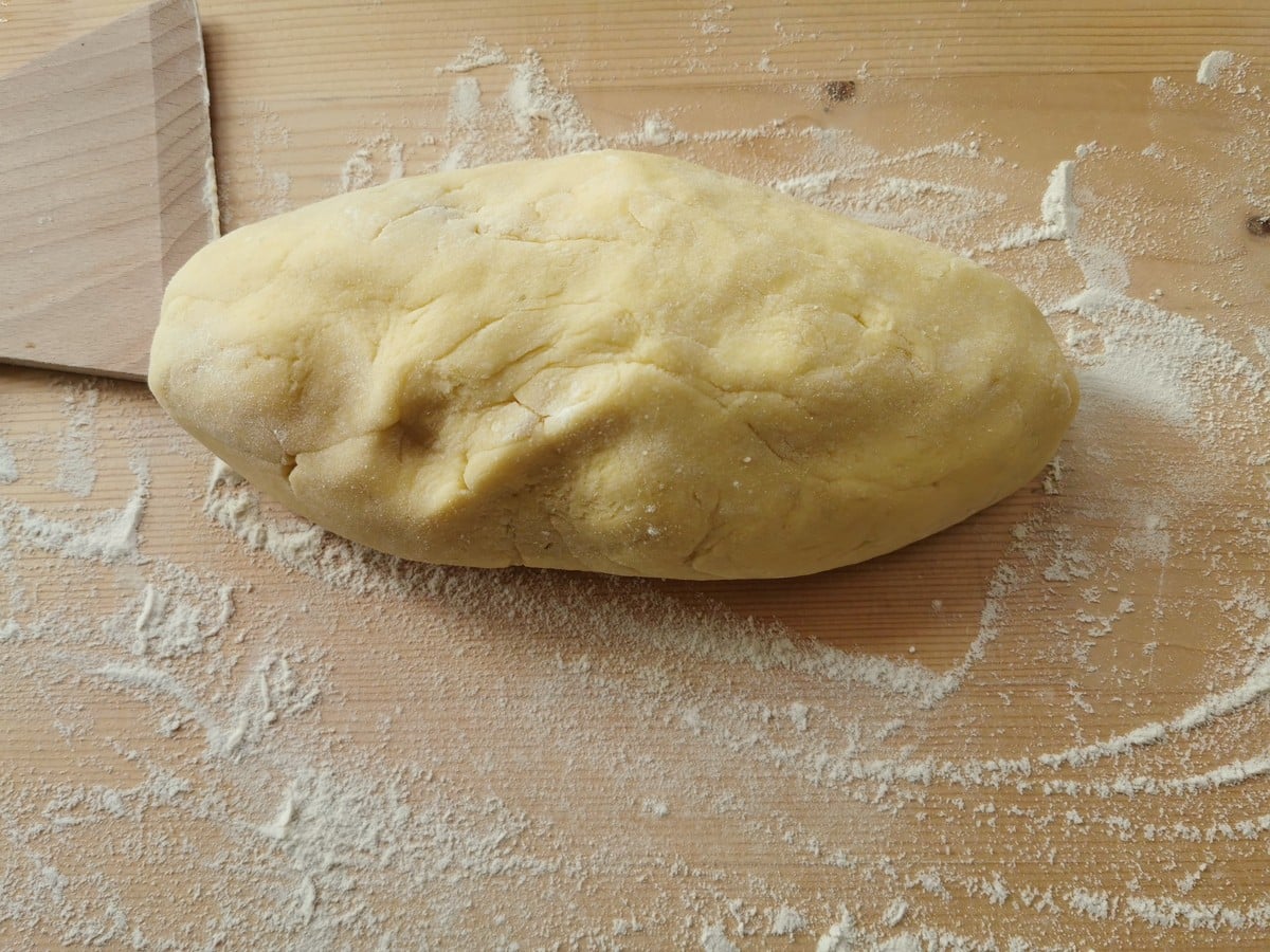 ready gnocchi dough on floured wooden pastry board