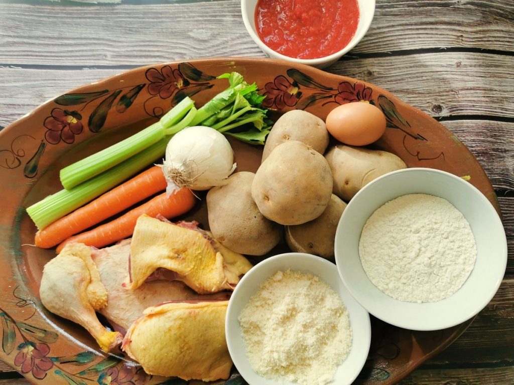 ingredients for homemade potato gnocchi with duck ragu on oval terracotta plate