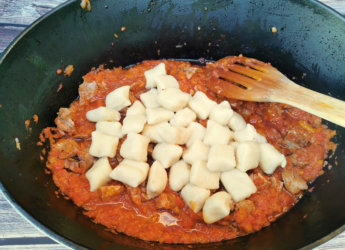 cooked potato gnocchi with duck ragu in Dutch oven