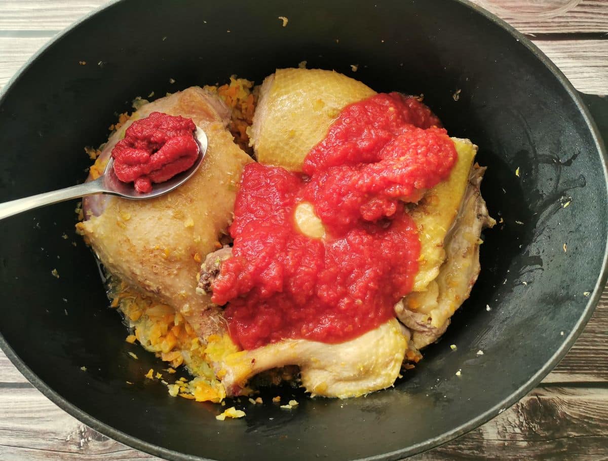 Duck pieces, vegetables, tomato Passata and paste in Dutch oven