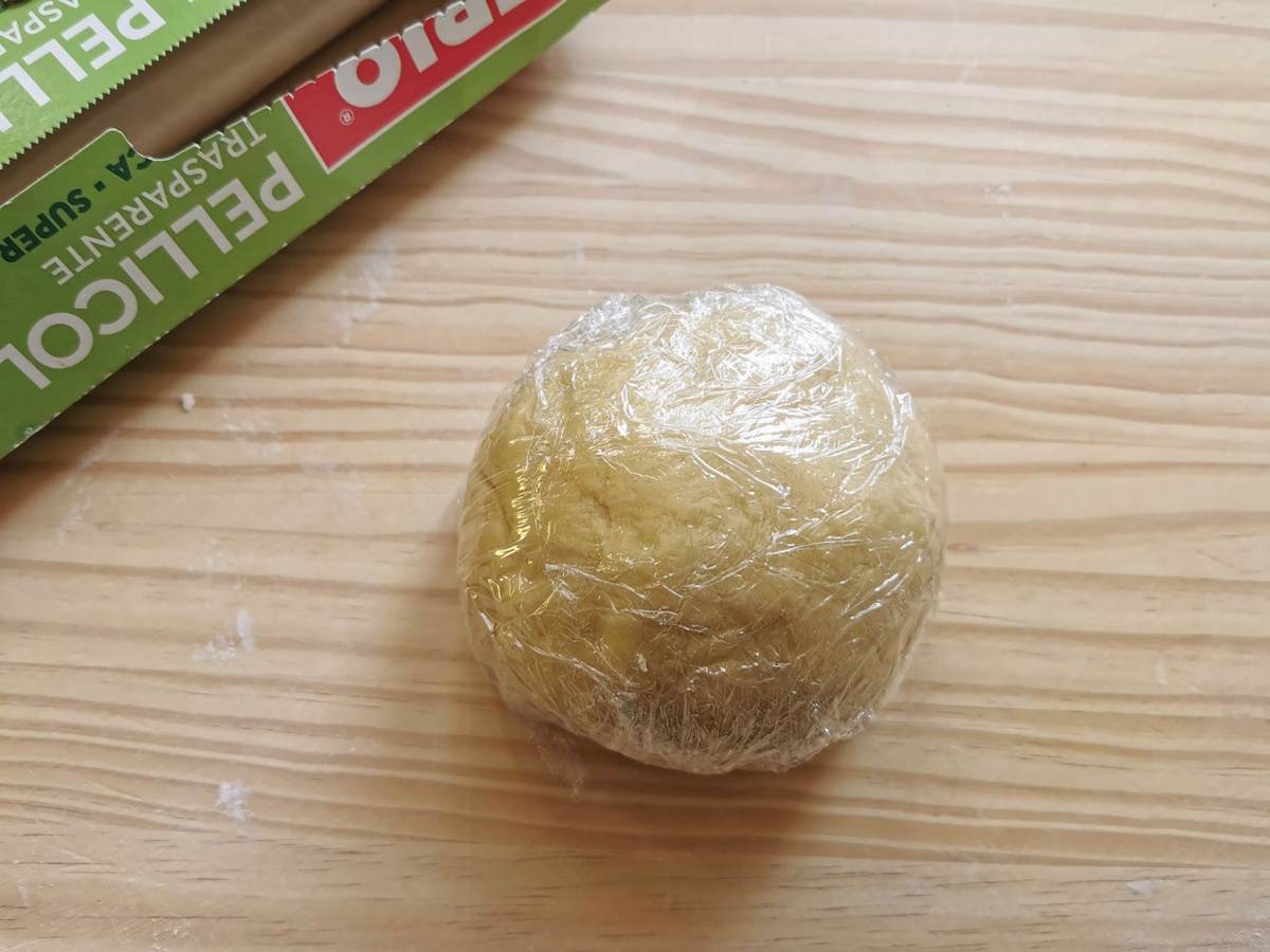 Ready ball of tagliatelle dough wrapped in cling film (palstic wrap).