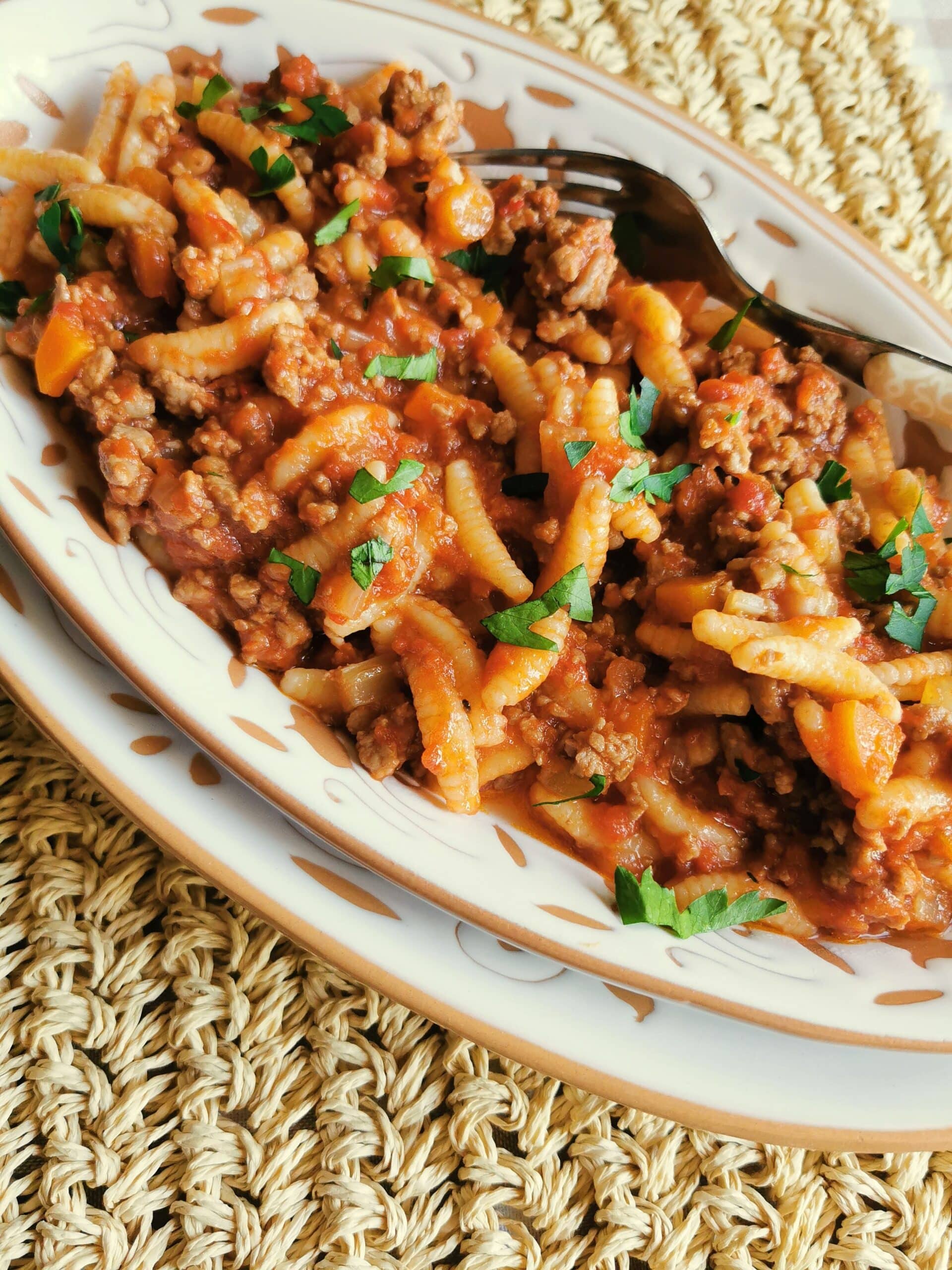 Lamb ragu with pasta on a plate.