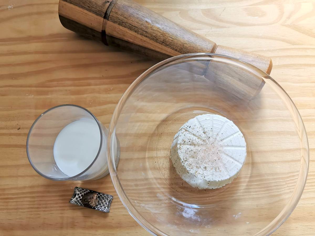 Ingredients for ricotta cream on wood work top.