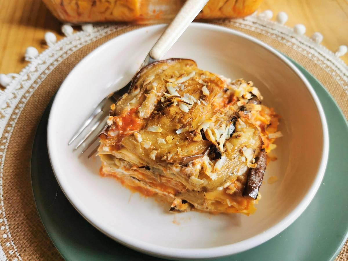 Portion of lasagna alla norma in white bowl.