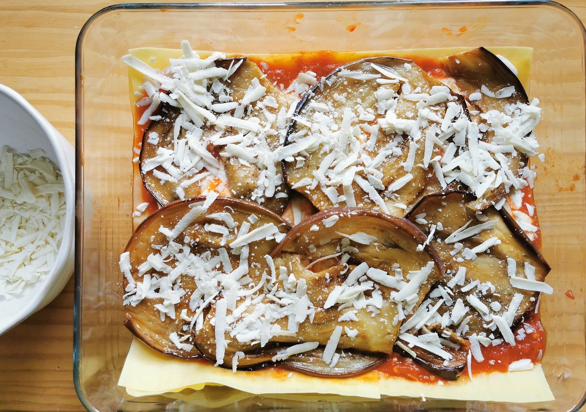 Lasagna alla norma ready to bake in rectangular glass oven dish.