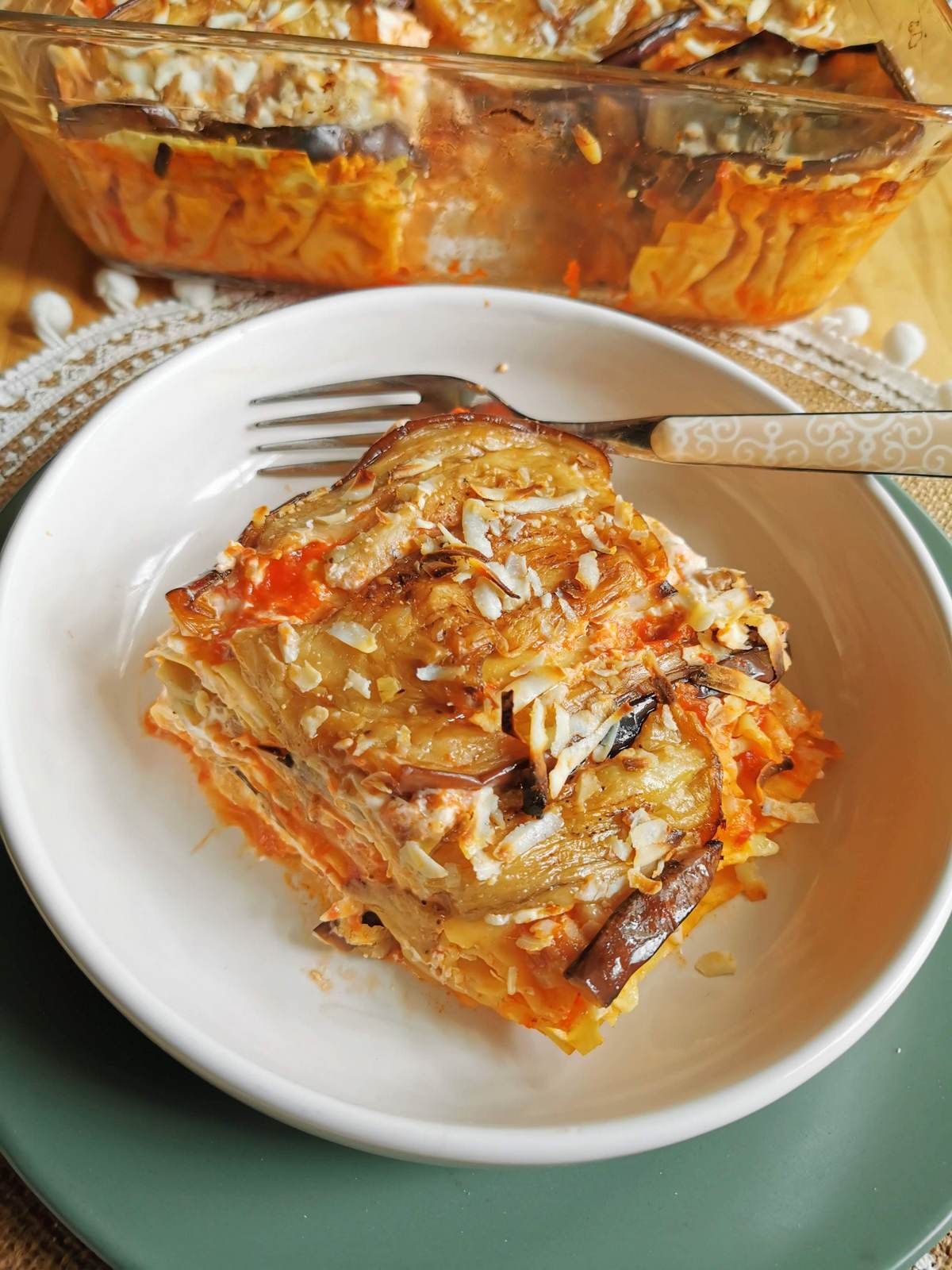 Portion of eggplant lasagna alla Norma in white bowl.