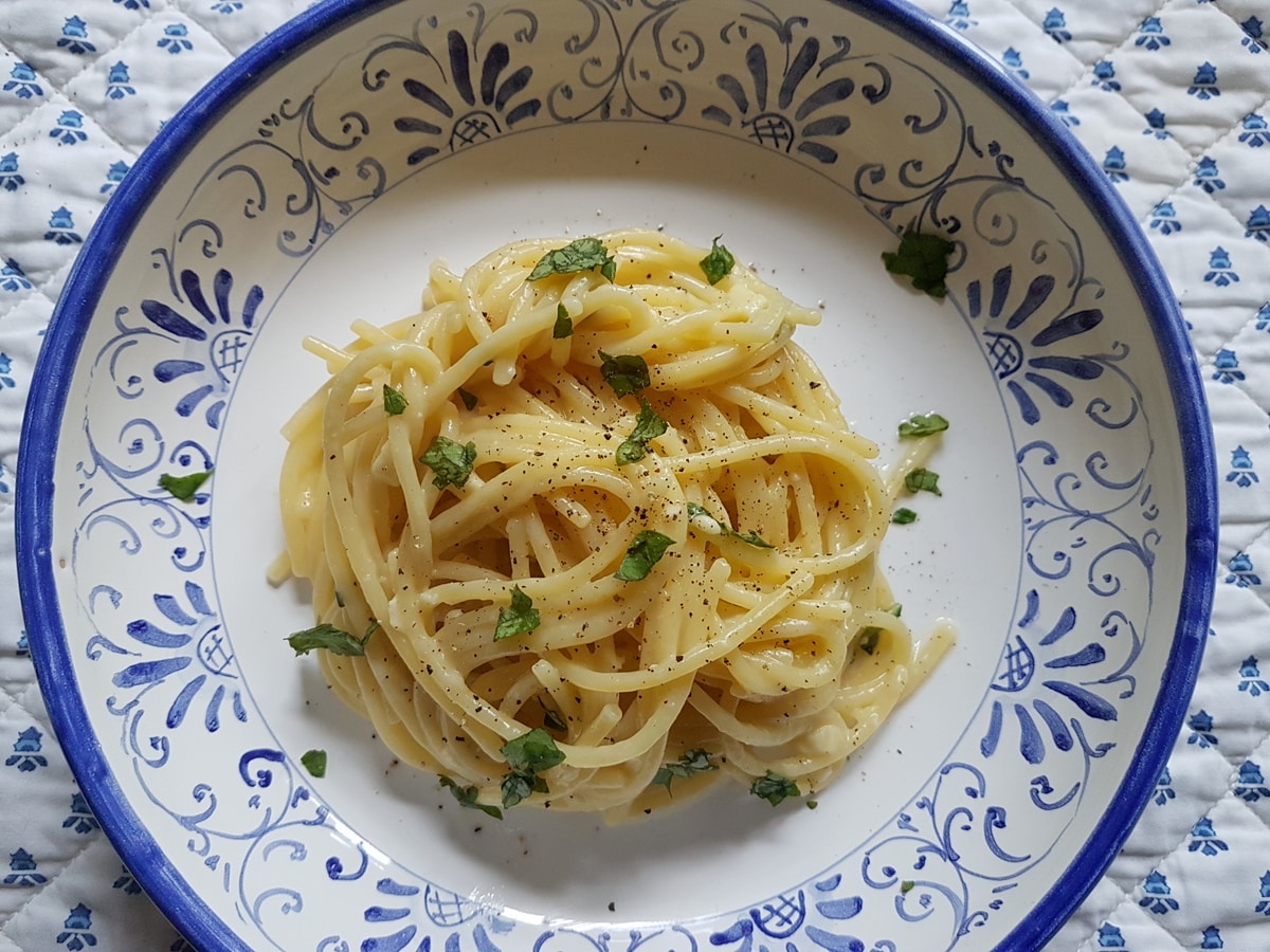 Lemon pasta water recipe that has been garnished with basil.