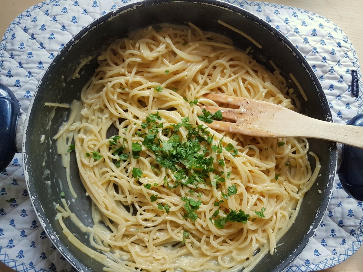 Lemon pasta in a pan with basil.