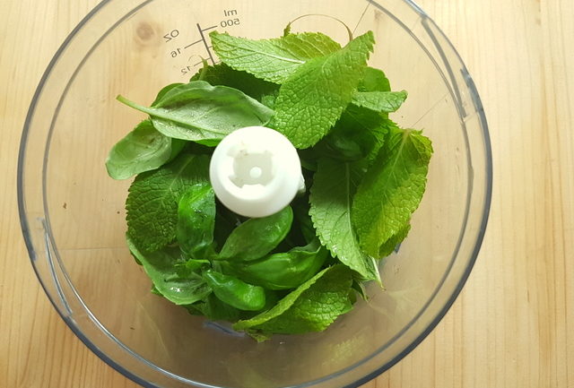 fresh mint and basil leaves in food blender