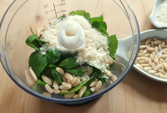 Fresh mint and basil leaves, pine nuts and grated Parmesan in food blender