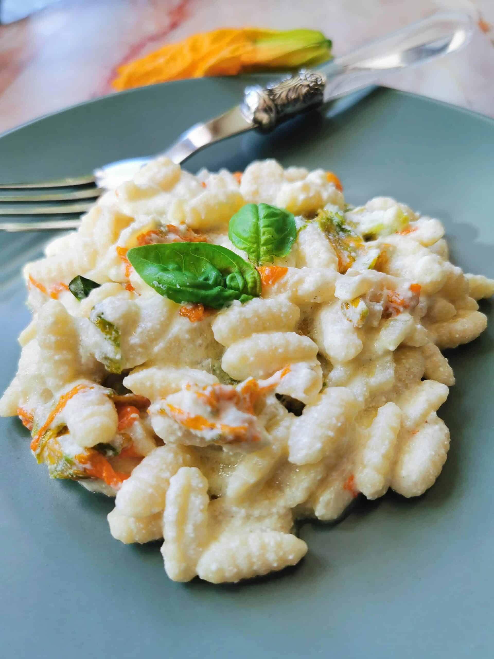 Pasta with zucchini flowers in a creamy ricotta and saffron sauce.