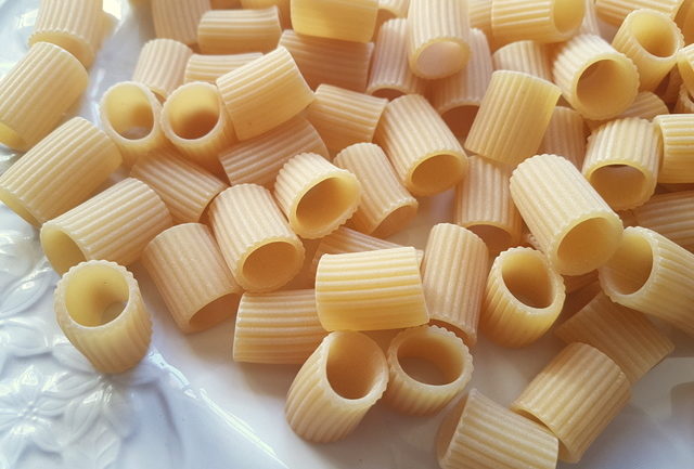 close up of mezze maniche pasta tubes on white plate