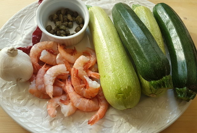 ingredients for mezze maniche pasta with zucchini and prawns 