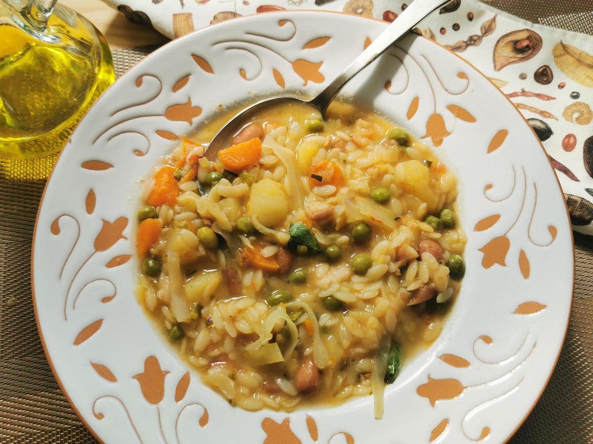 Minestrone Milanese in white and terracotta bowl.