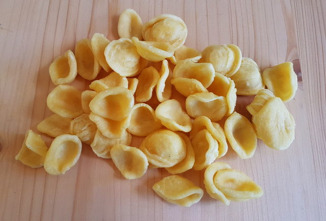 fresh orecchiette on wooden board for orecchiette with broccoli rabe recipe