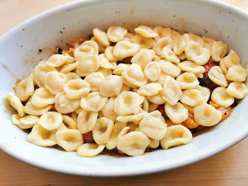cooked orecchiette in oven dish with roasted tomato sauce