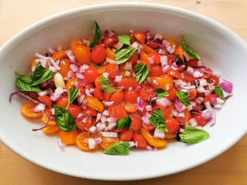 prepared condiment ingredients in white oven dish