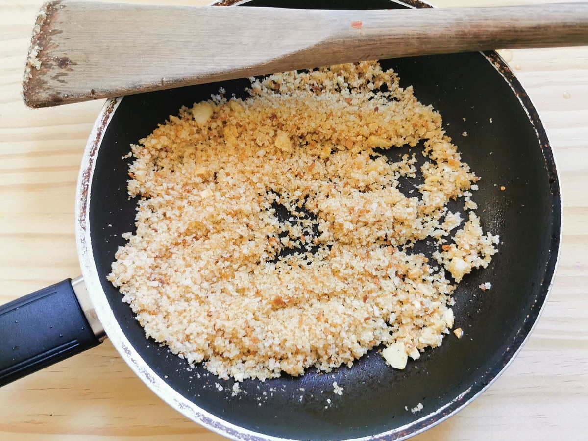 Breadcrumbs and garlic toasting in a pan.