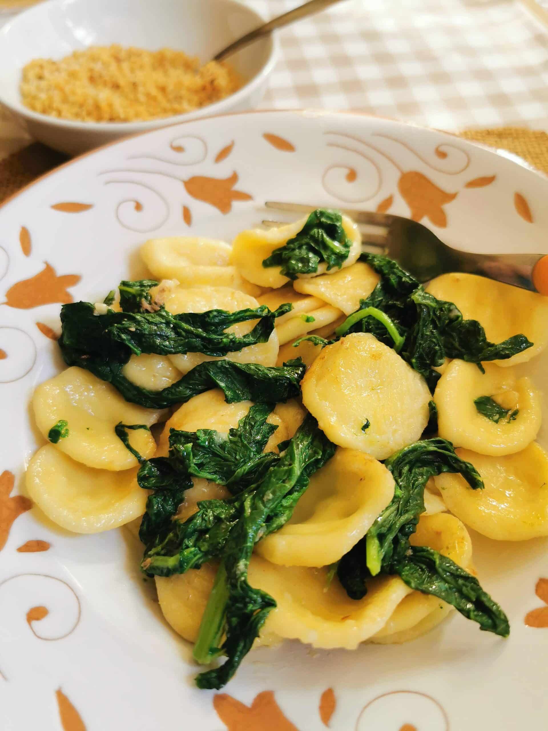 Orecchiette with broccoli rabe in a bowl with a fork.