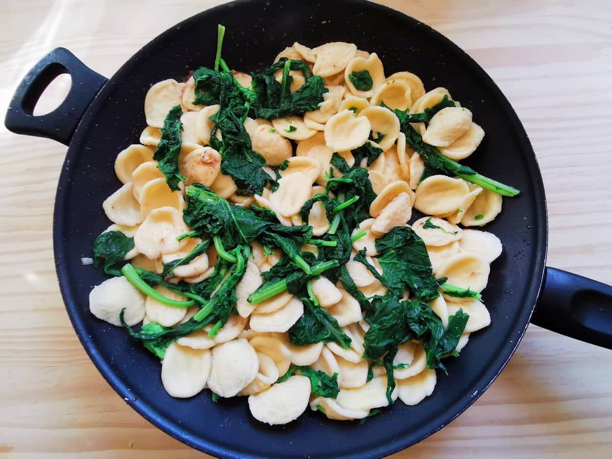 Orecchiette and broccoli rabe in a pan.