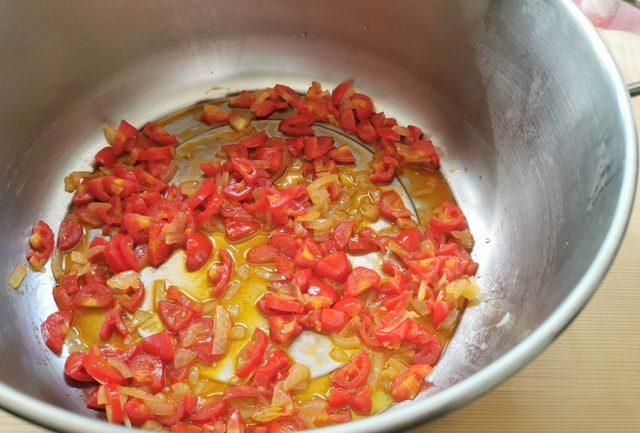 onions and small tomatoes cooking in olive oil