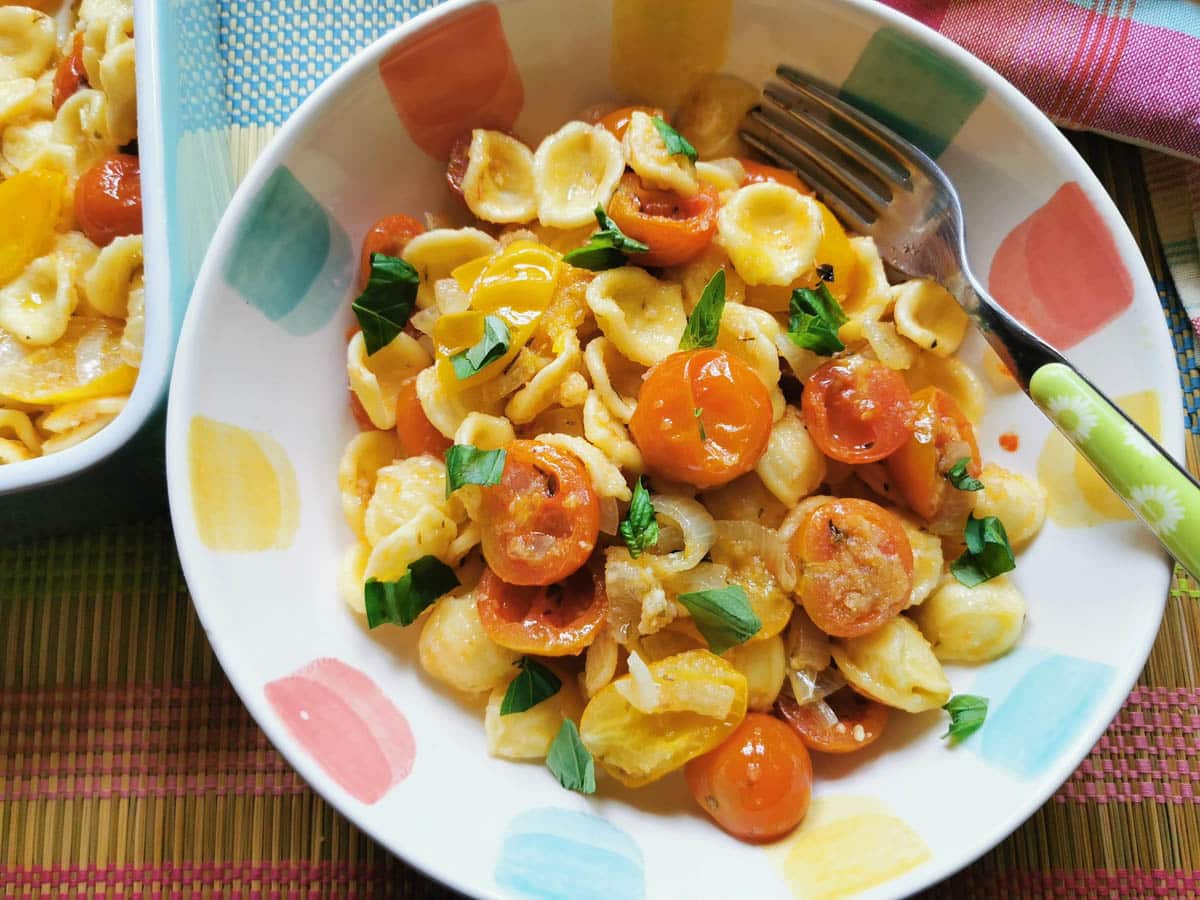 roasted cherry tomato pasta in a bowl with basil