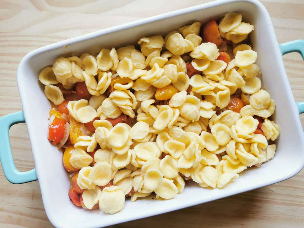 orecchiette pasta and cherry tomatoes in a baking dish